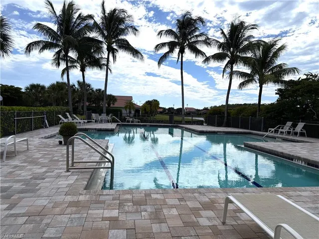 a view of swimming pool with a table and chairs
