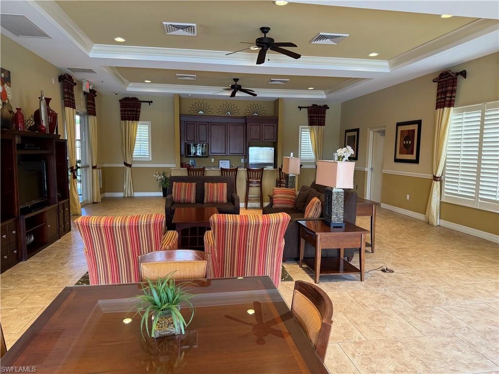 13462 Kent Street Naples, FL 34109 - Photo 30 of 30 a living room with patio furniture and a flat screen tv