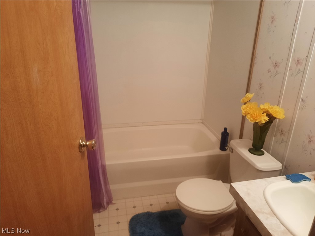 3973 Mill Road Dorset, OH 44032 - Photo 10 of 13 Full bathroom with shower / tub combo, vanity, and light tile floors