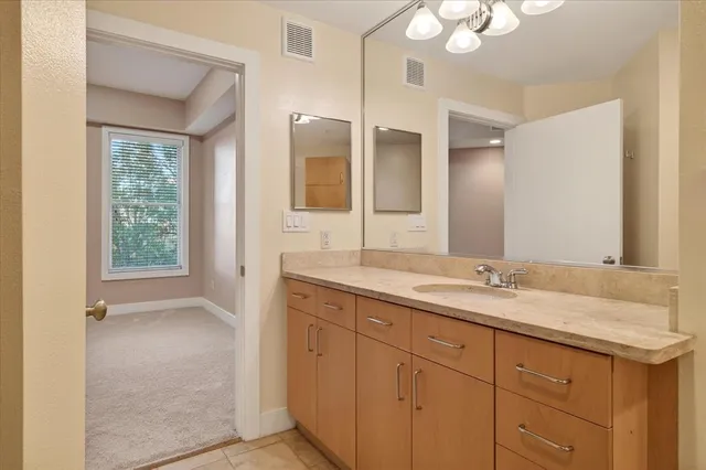 a bathroom with a granite countertop sink mirror and double