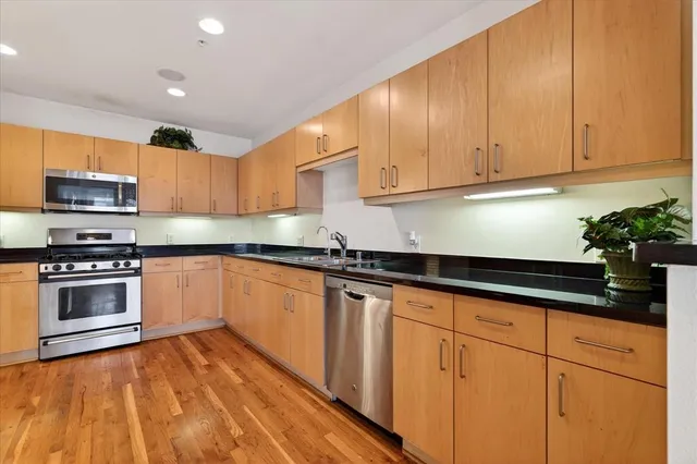 a kitchen with granite countertop a sink and cabinets
