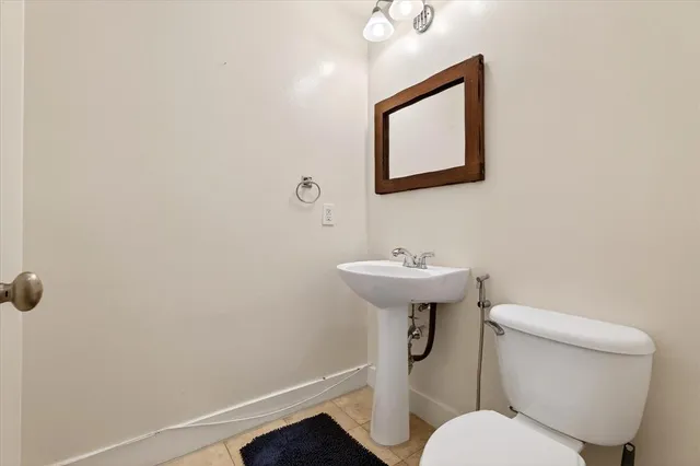 a white toilet sitting next to a bathroom sink
