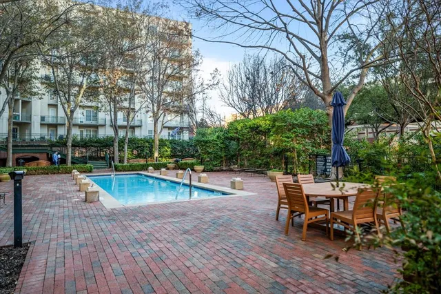 a view of a swimming pool with sitting area and furniture