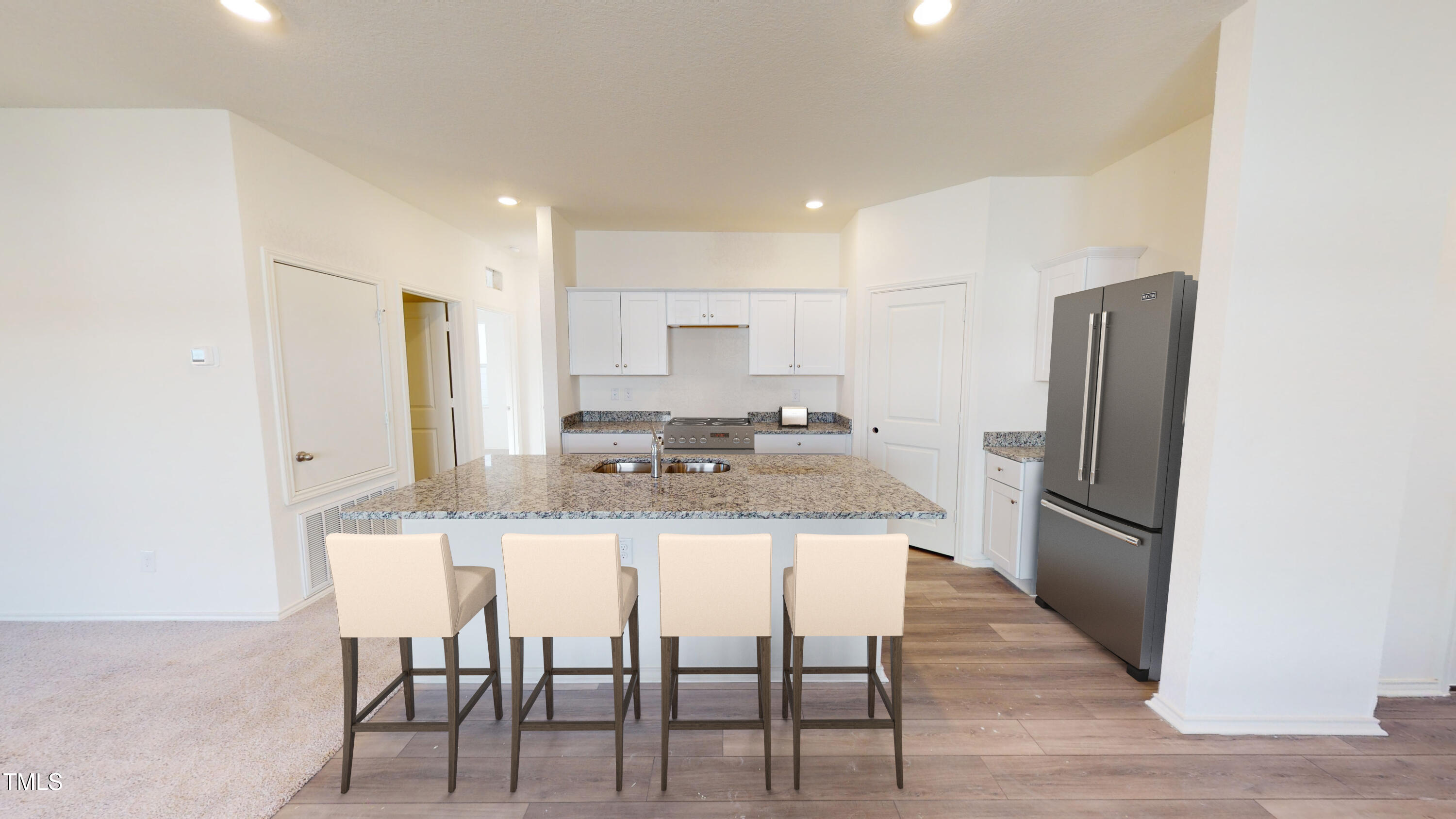 885 Embraer Way Spring Spring Hope, NC 27882 - Photo 8 of 35 a kitchen with stainless steel appliances granite countertop a dining table chairs refrigerator and sink