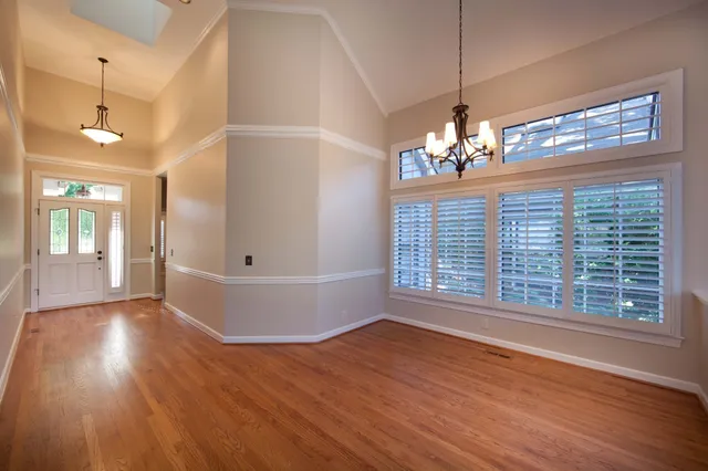 a view of a livingroom with wooden floor and a large window