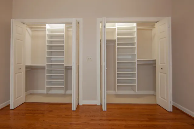 a view of walk in closet with empty racks