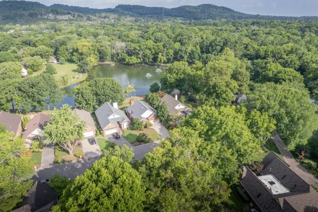 an aerial view of a house with yard and outdoor seating
