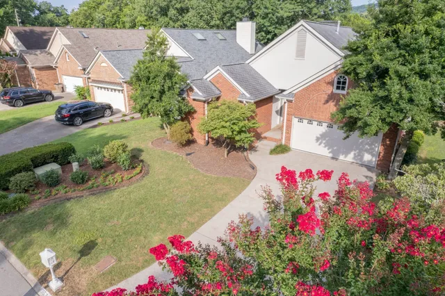 a view of a house with a yard and garden