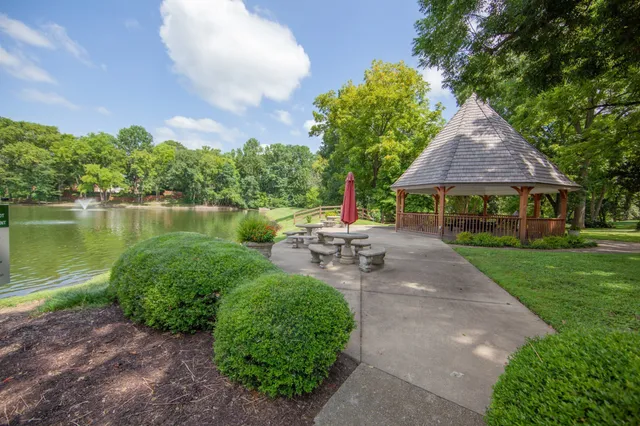 a view of a patio with table and chairs under an umbrella