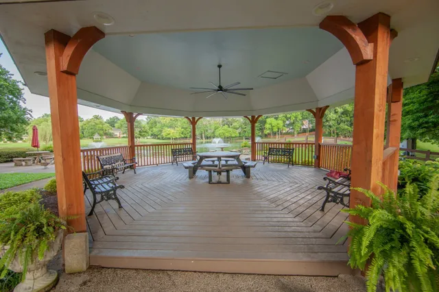 a view of a patio with table and chairs potted plants with wooden floor