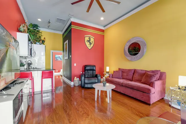 a living room with furniture and a wooden floor