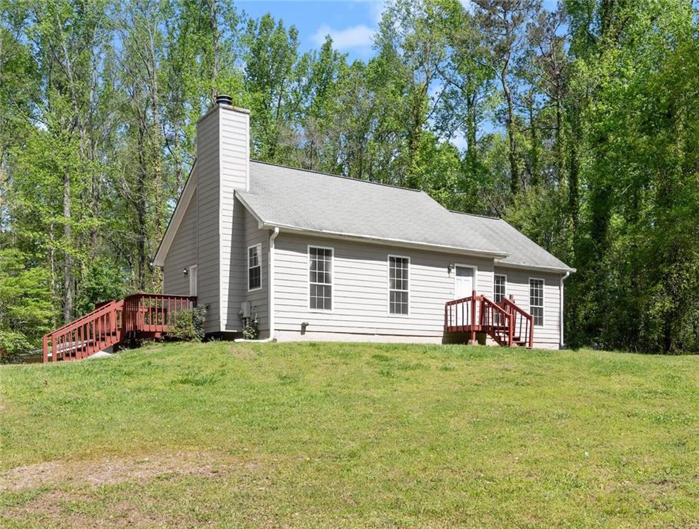 3298 Aaron Sosebee Road Cumming, GA 30028 - Photo 1 of 1 a view of a house with backyard and trees