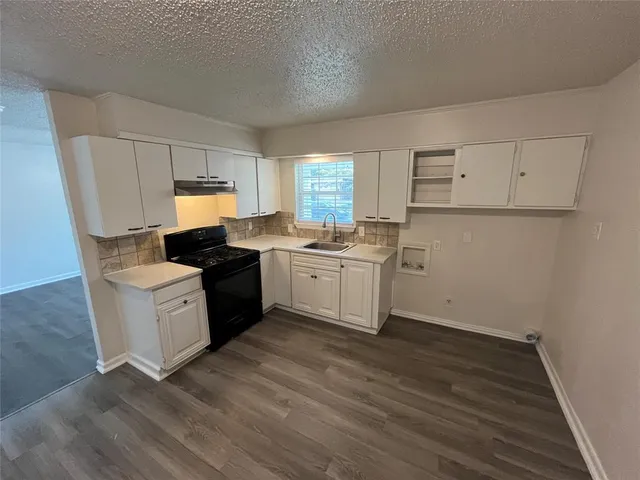a kitchen with a white cabinets and white appliances