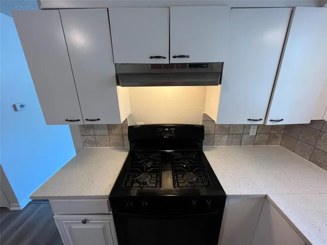 a kitchen with a stove and a sink