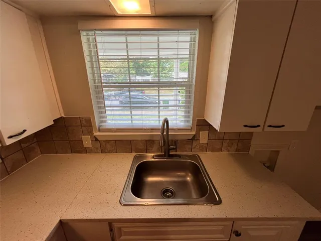 a kitchen with a sink a window and a stove