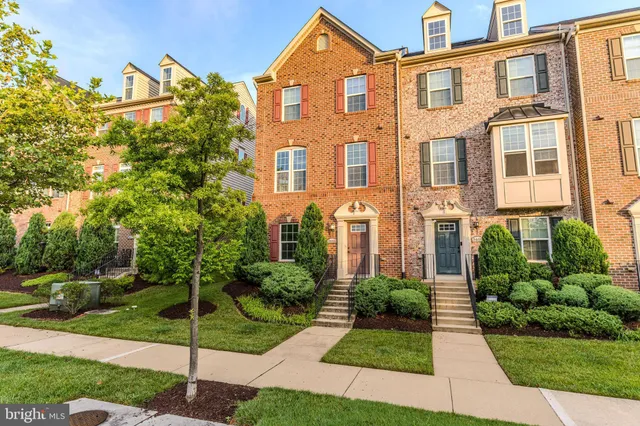a front view of a residential apartment building with a yard
