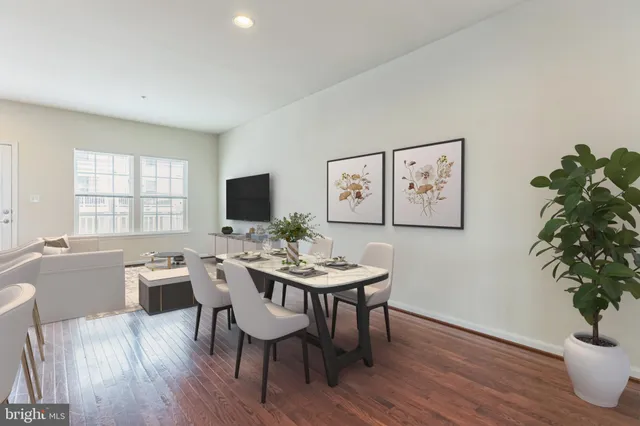 a view of a dining room with furniture window and wooden floor