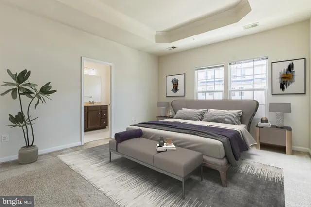 a spacious bedroom with a bed and a couch