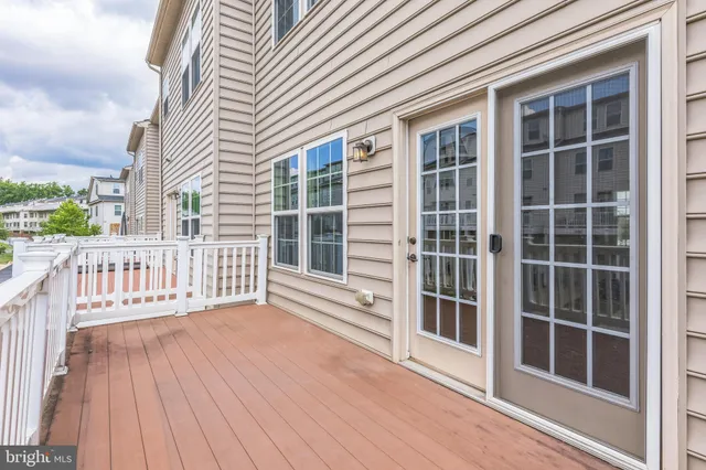 a view of a balcony with wooden floor and fence