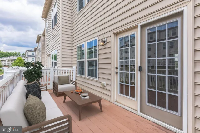 a balcony with furniture and a potted plant