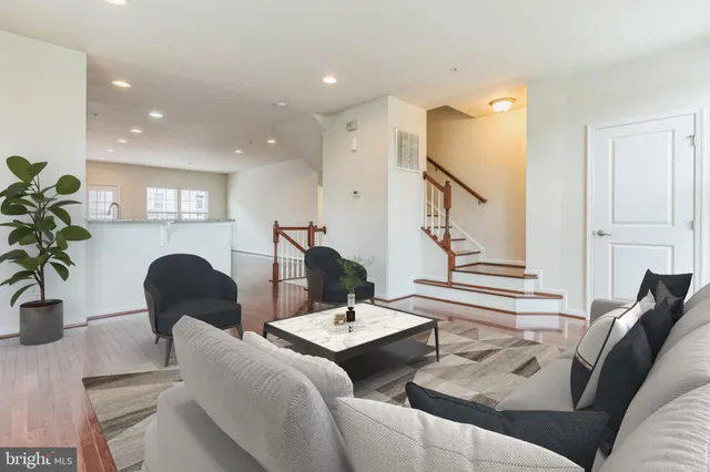 a living room with furniture and a potted plant