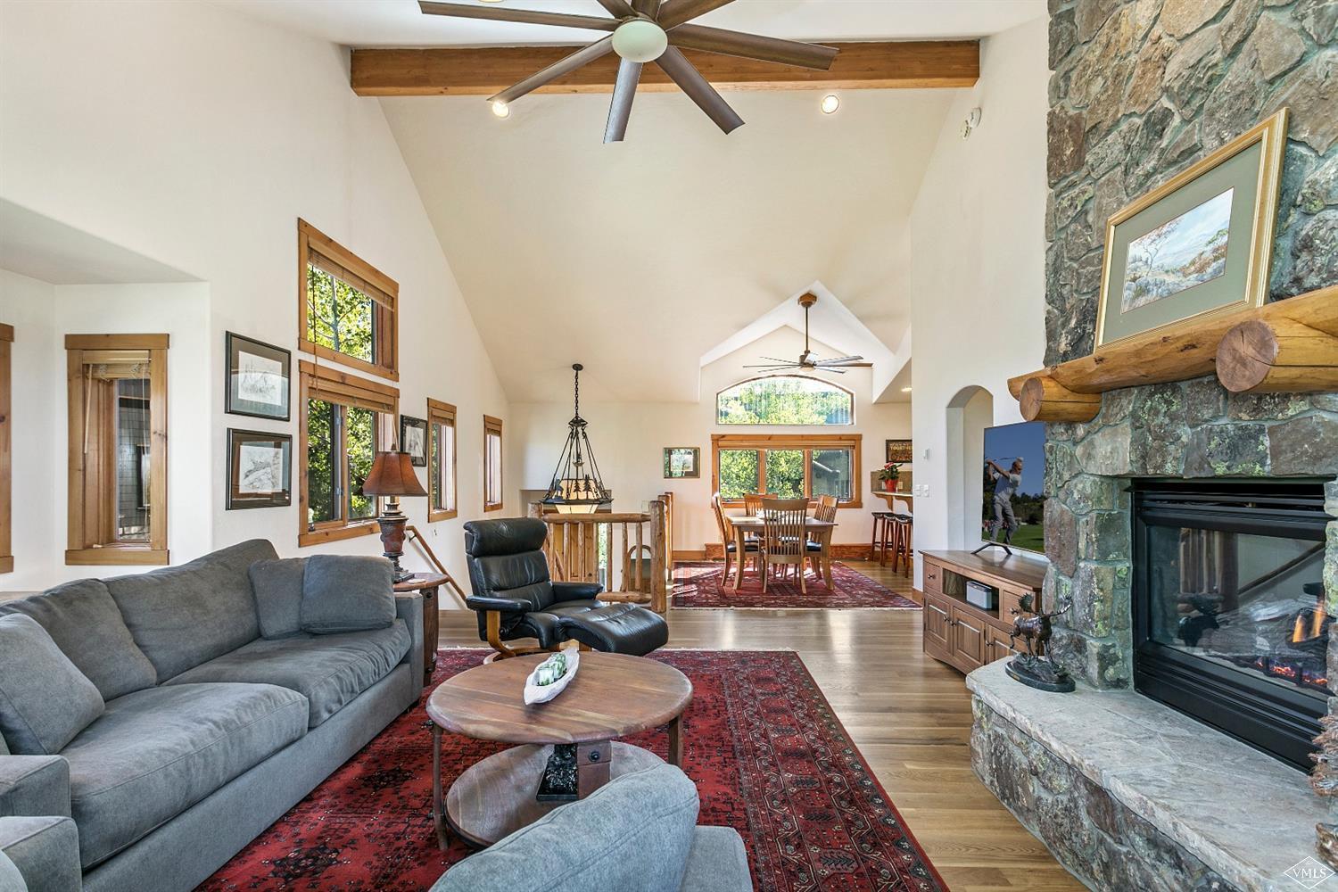 49 Knudson Ranch Road Edwards, CO 81632 - Photo 4 of 20 a living room with furniture a fireplace and a chandelier