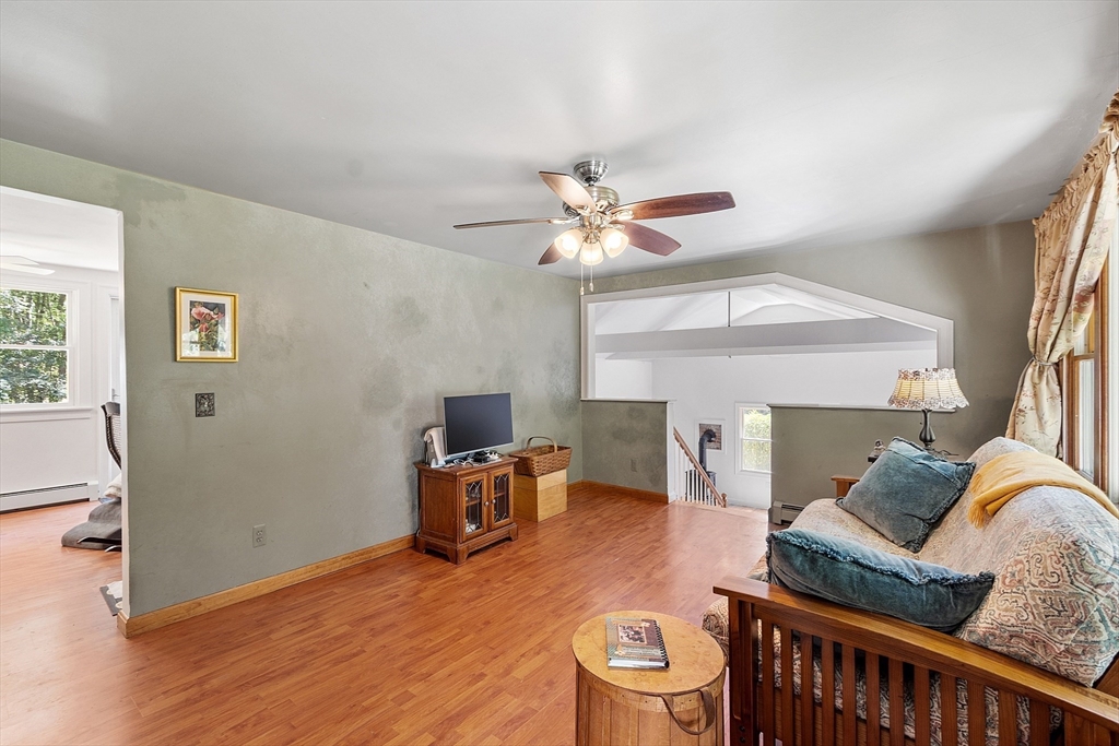 111 Wheeler Road Princeton, MA 01541 - Photo 14 of 42 a living room with furniture and a wooden floor