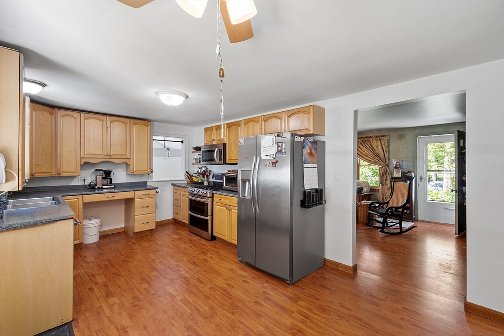 111 Wheeler Road Princeton, MA 01541 - Photo 15 of 42 a kitchen with stainless steel appliances a refrigerator a sink dishwasher a stove and white cabinets with wooden floor