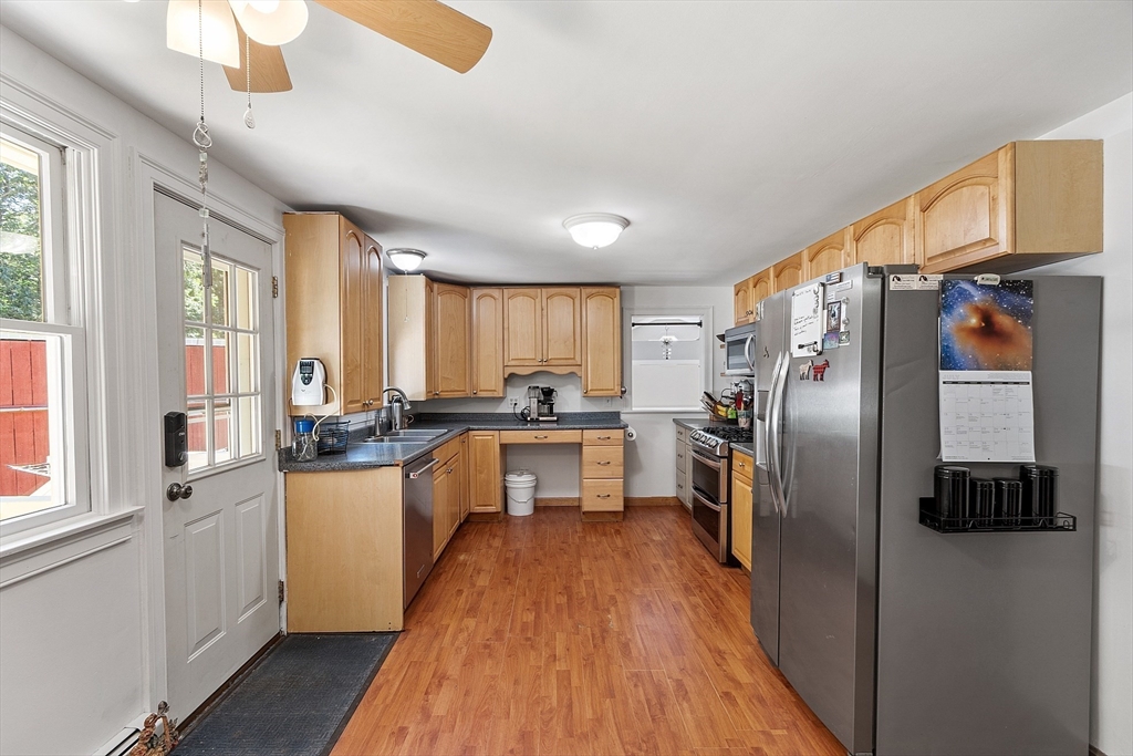 111 Wheeler Road Princeton, MA 01541 - Photo 16 of 42 a kitchen with granite countertop a refrigerator a sink dishwasher a stove and white cabinets with wooden floor