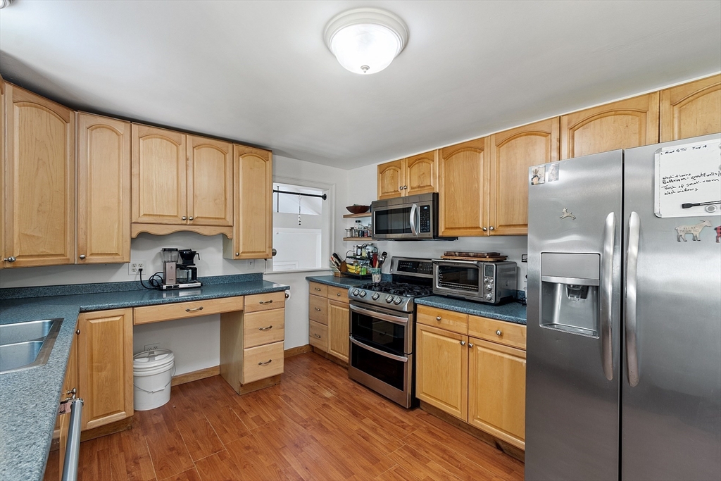 111 Wheeler Road Princeton, MA 01541 - Photo 18 of 42 a kitchen with stainless steel appliances granite countertop a stove top oven a sink and dishwasher a refrigerator with wooden floor