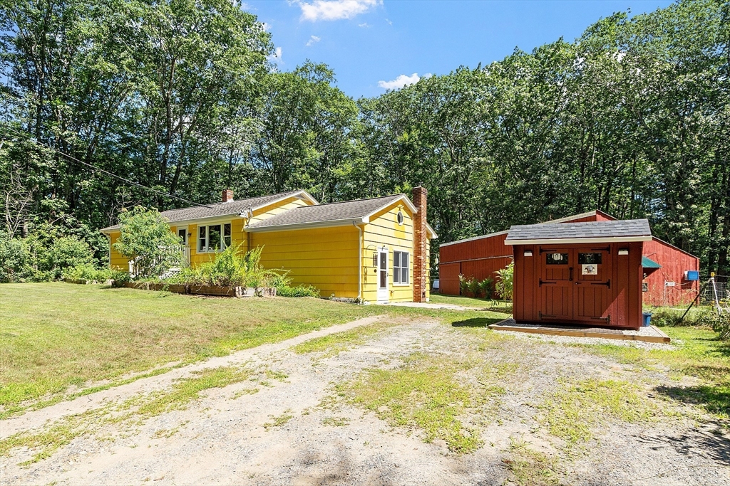 111 Wheeler Road Princeton, MA 01541 - Photo 2 of 42 a house view with a garden space