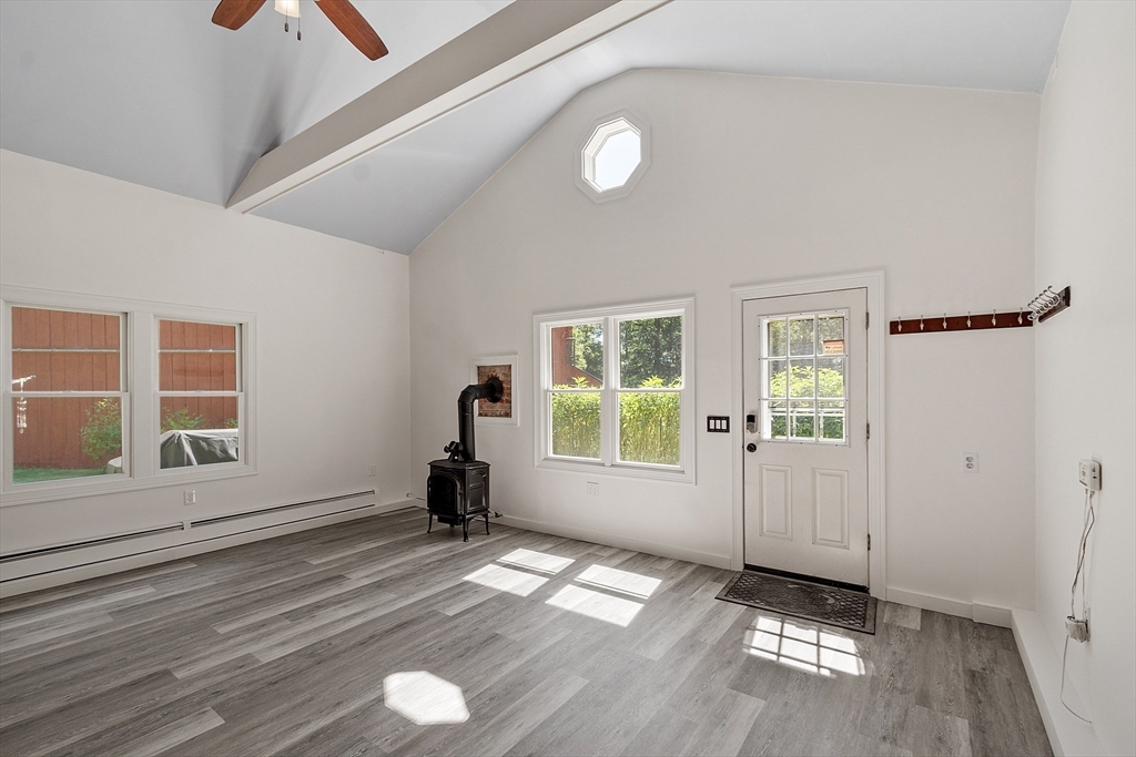 111 Wheeler Road Princeton, MA 01541 - Photo 5 of 42 an empty room with wooden floor and windows
