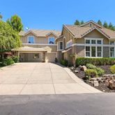 a view of multiple houses with yard and green space