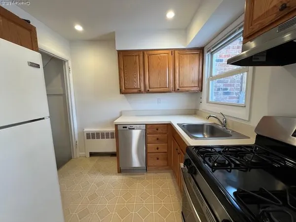 a kitchen with a stove and a refrigerator