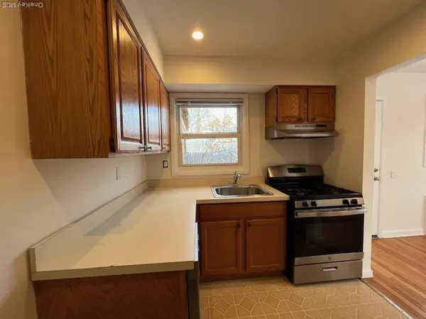 a kitchen with stainless steel appliances a stove a sink and a microwave