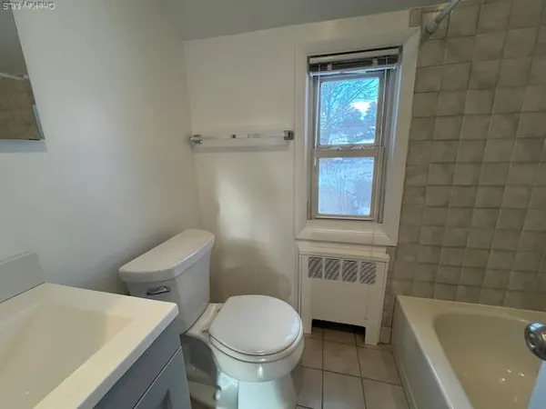 a bathroom with a sink a toilet and bathtub