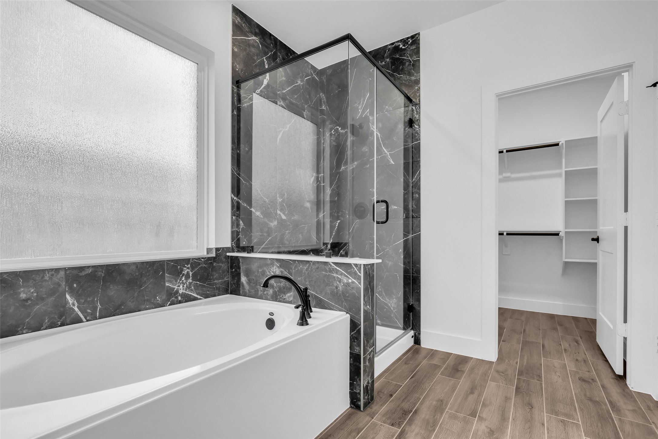 12853 Meadow Wind Way Conroe, TX 77302 - Photo 25 of 47 Primary Suite Bath welcomes you into this spa like retreat with large soaking tub, Walk in Shower and Generous sized Walk in Closet.