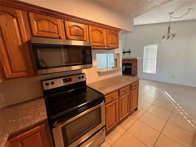 a kitchen with stainless steel appliances granite countertop a stove and a microwave