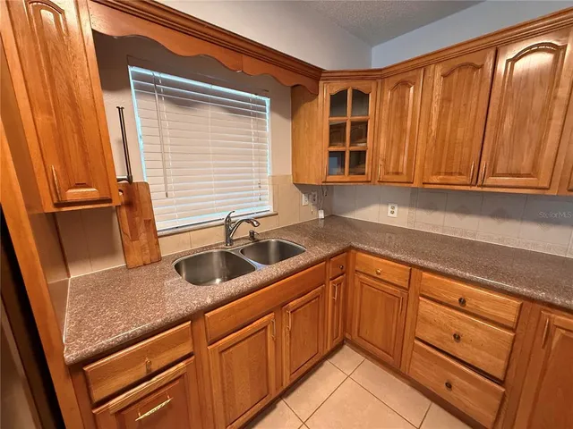 a kitchen with granite countertop a sink and dishwasher a cabinets with wooden floor