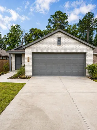 a front view of house with yard garage and green space