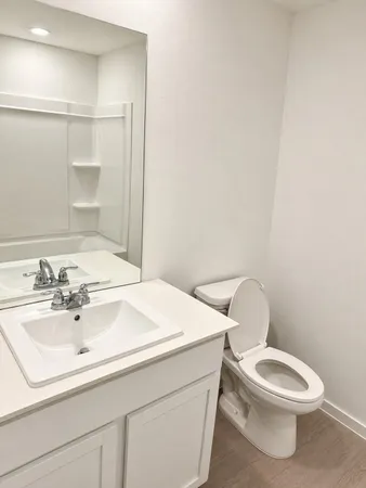 a bathroom with a sink a toilet and vanity