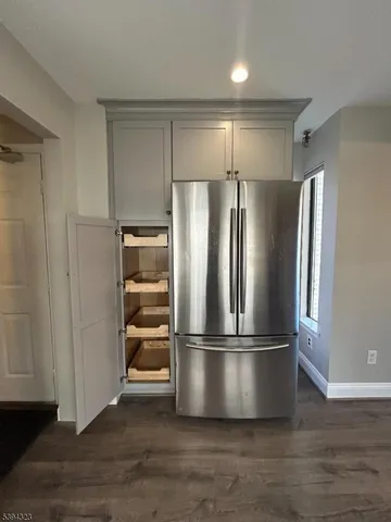a view of a kitchen with a sink dishwasher a refrigerator and a fireplace