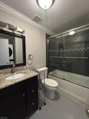 a en suite bathroom with a granite countertop sink and a mirror