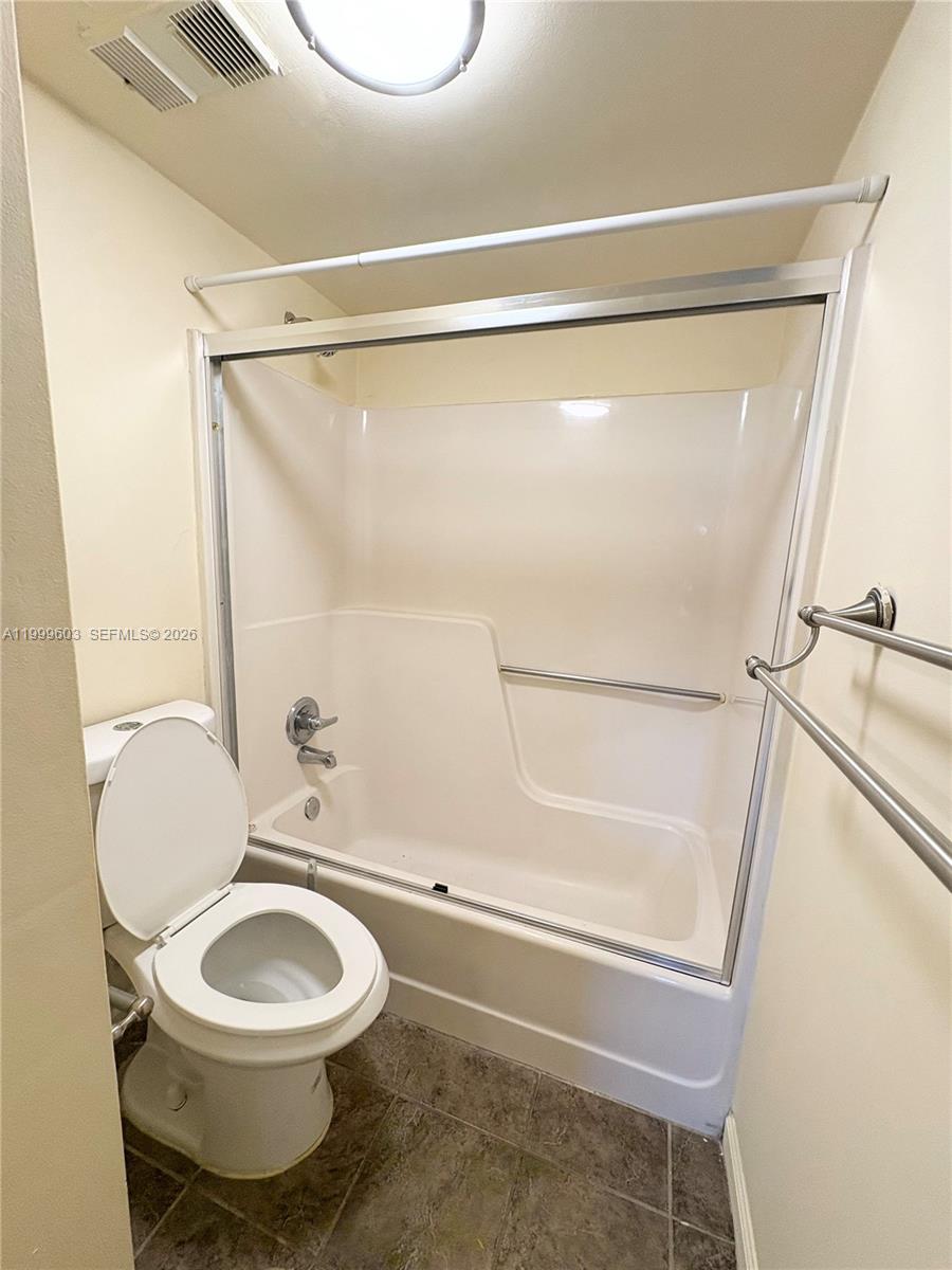 21904 Lake Forest Circle, Unit 203 Boca Raton, FL 33433 - Photo 10 of 11 a bathroom with a toilet and a shower