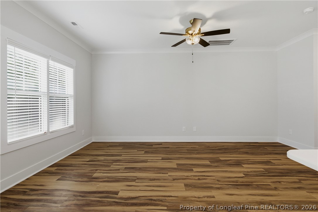 3931 Hamilton Street Hope Mills, NC 28348 - Photo 14 of 50 a view of a room with wooden floor and a ceiling fan