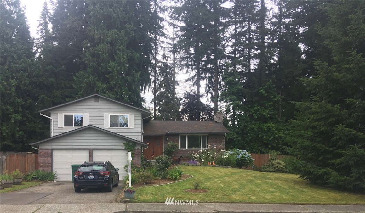 3302 198th Place Southeast Bothell, WA 98012 - Photo 1 of 19 a front view of a house with garage
