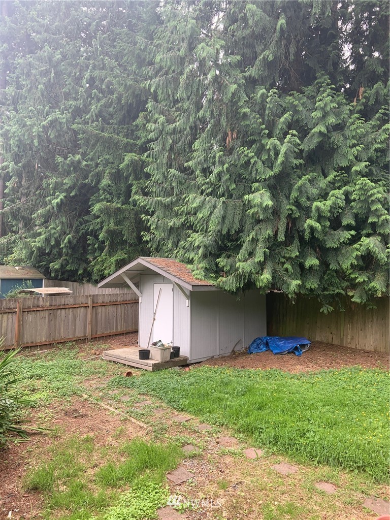 3302 198th Place Southeast Bothell, WA 98012 - Photo 19 of 19 a view of a backyard with a small cabin and wooden fence