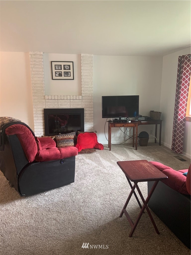 3302 198th Place Southeast Bothell, WA 98012 - Photo 3 of 19 a living room with furniture and a flat screen tv