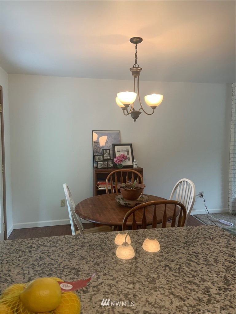 3302 198th Place Southeast Bothell, WA 98012 - Photo 8 of 19 a dining room with furniture and a chandelier