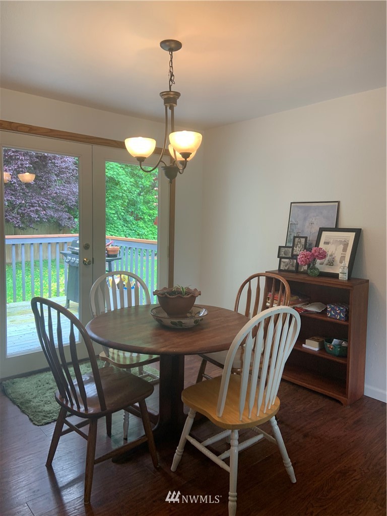 3302 198th Place Southeast Bothell, WA 98012 - Photo 9 of 19 a view of a dining room with furniture window and wooden floor